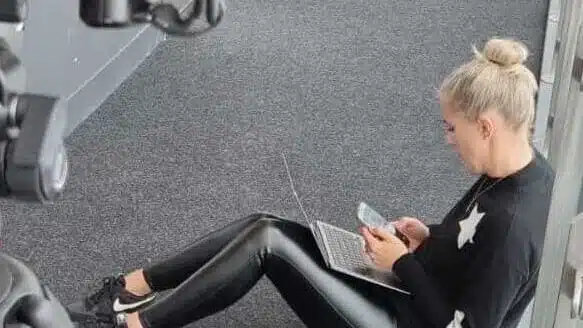 Being multi-skilled in the creative industry means multi-tasking as Lucie is in this image, working on her phone, laptop and in the gym.
