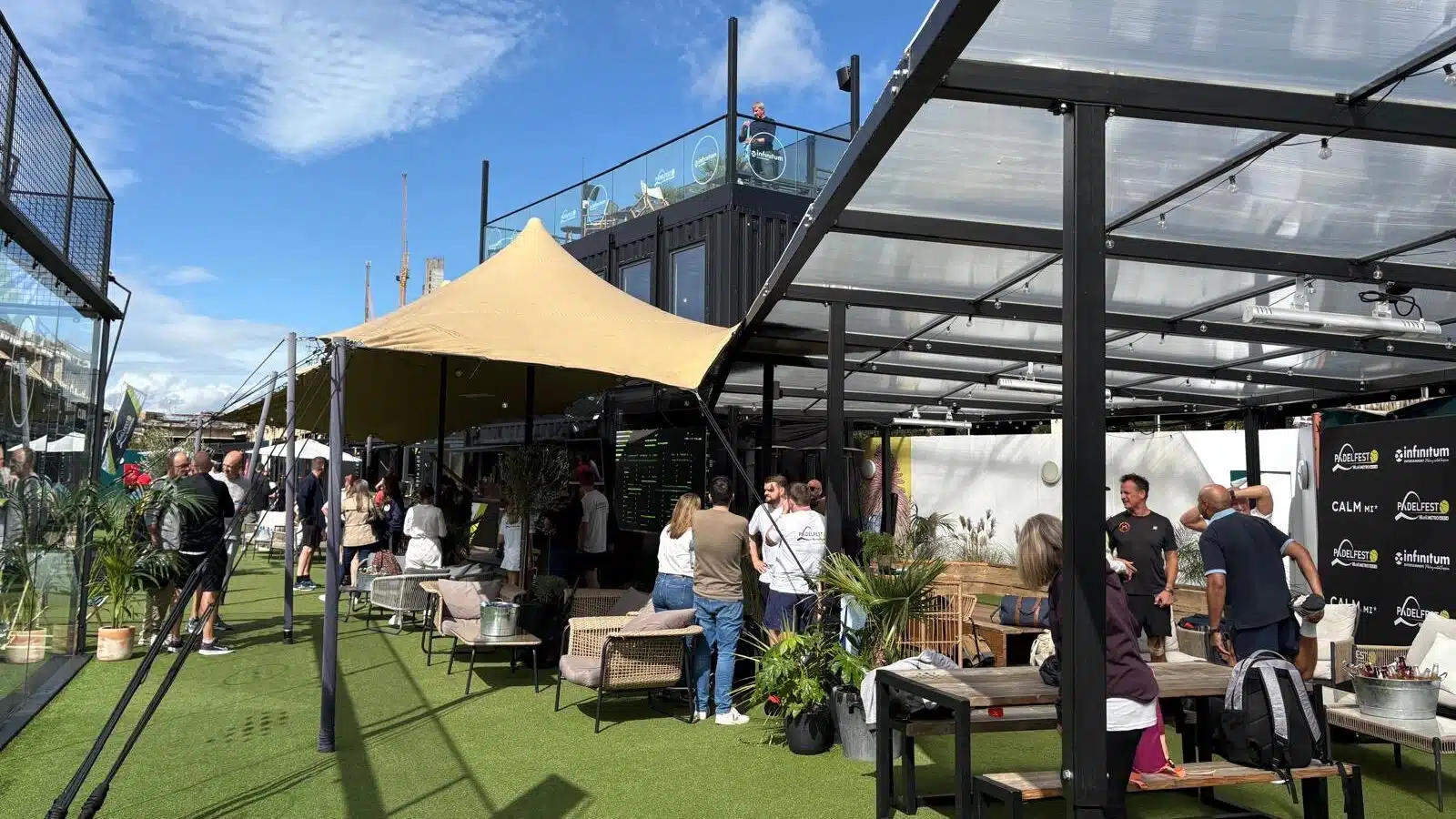 Padelfest 2025: Glass padel courts and lots of people socialising. 